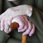 Guardianship-elderly hands on cane