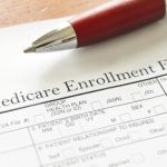 Closeup of Medicare enrollment form and pen