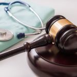 Personal Injury Facts - Gavel and stethoscope in background. Medical laws and legal concepts