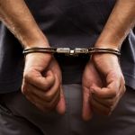 Lesser-Known Facts About Criminal Defense - Close-up. Arrested man handcuffed