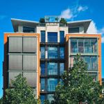 NH-real-estate-transfer-tax-modern apartment building with trees blue sky
