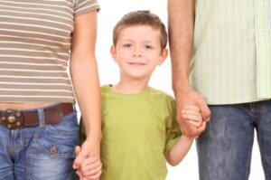 5-6 years old boy with his parents isolated on white