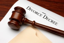 Divorce decree, gavel and folder shot on warm wooden surface