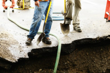 business lawyer - Standing on the edge of a exchavation hole to repair a 12 inch water main failure on Harvard Ave in Roseburg OR