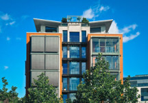 NH-real-estate-transfer-tax-modern apartment building with trees blue sky