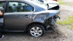 car-accident-lawyer - grey car rear bumper collision damage