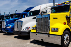 Truck Accident Lawyer Nashua, NH - Colorful Semi Tractor Trailer Trucks Lined up for Sale