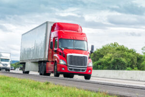 Truck Accident Lawyer Derry, NH - Red Eighteen Wheeler Travels Interstate Highway